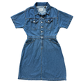 A short-sleeve denim shirt dress in medium blue wash, featuring a button-down front, chest flap pockets, and a matching fabric tie belt at the waist, shown flat on a white background.