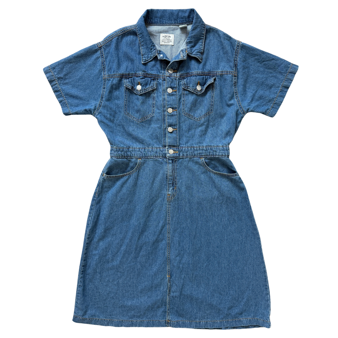 A short-sleeve denim shirt dress in medium blue wash, featuring a button-down front, chest flap pockets, and a matching fabric tie belt at the waist, shown flat on a white background.
