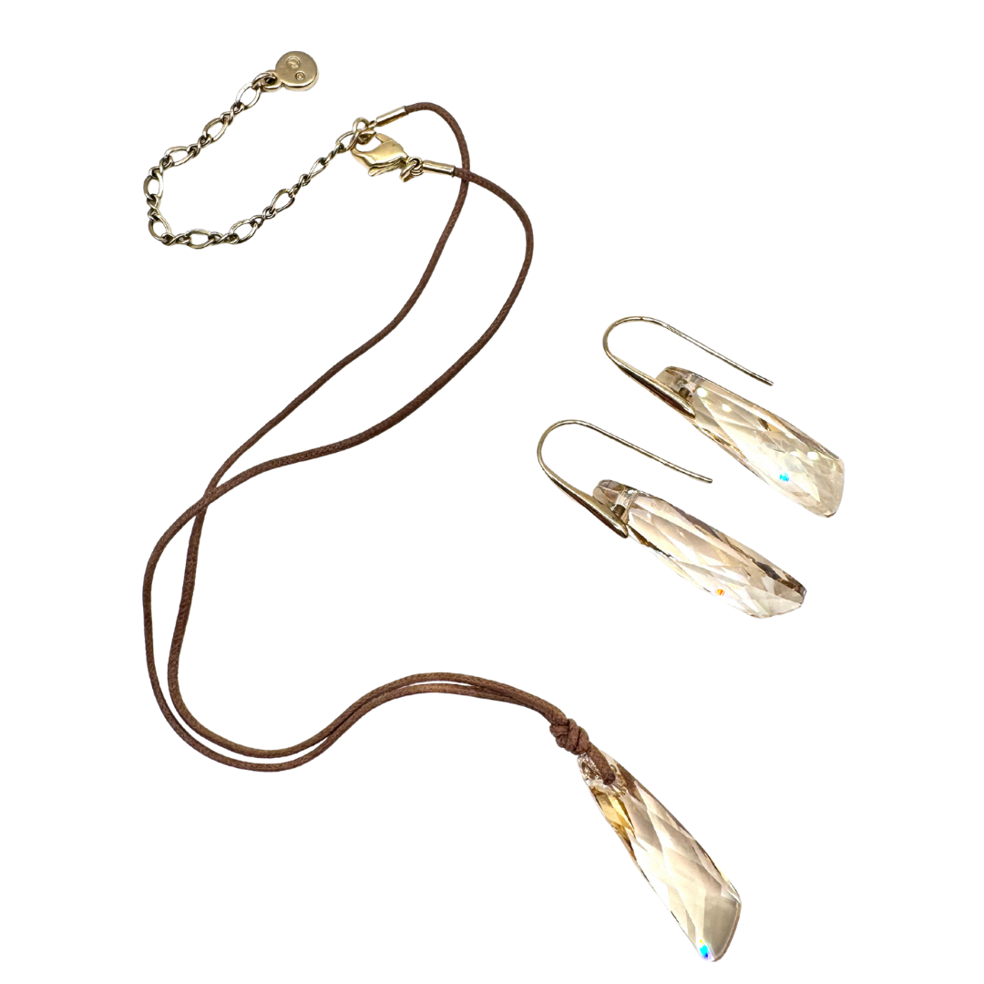 Genuine amber Swarovski crystal pendant necklace and earrings set. Earring hooks and necklace claps are made with 23k gold plated base metal and necklace is hung on fine brown suede cord. 