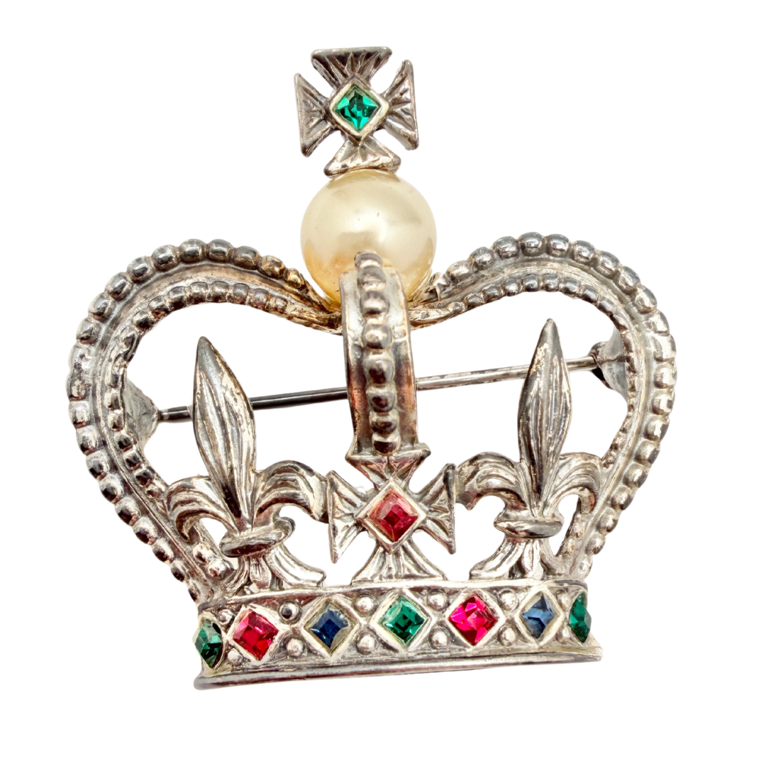 A rare vintage Marcel Boucher jewelled crown brooch, silver-tone featuring red, blue and green jewel-tone rhinestones and a single mabe pearl. Dated between 1944 and 1949.